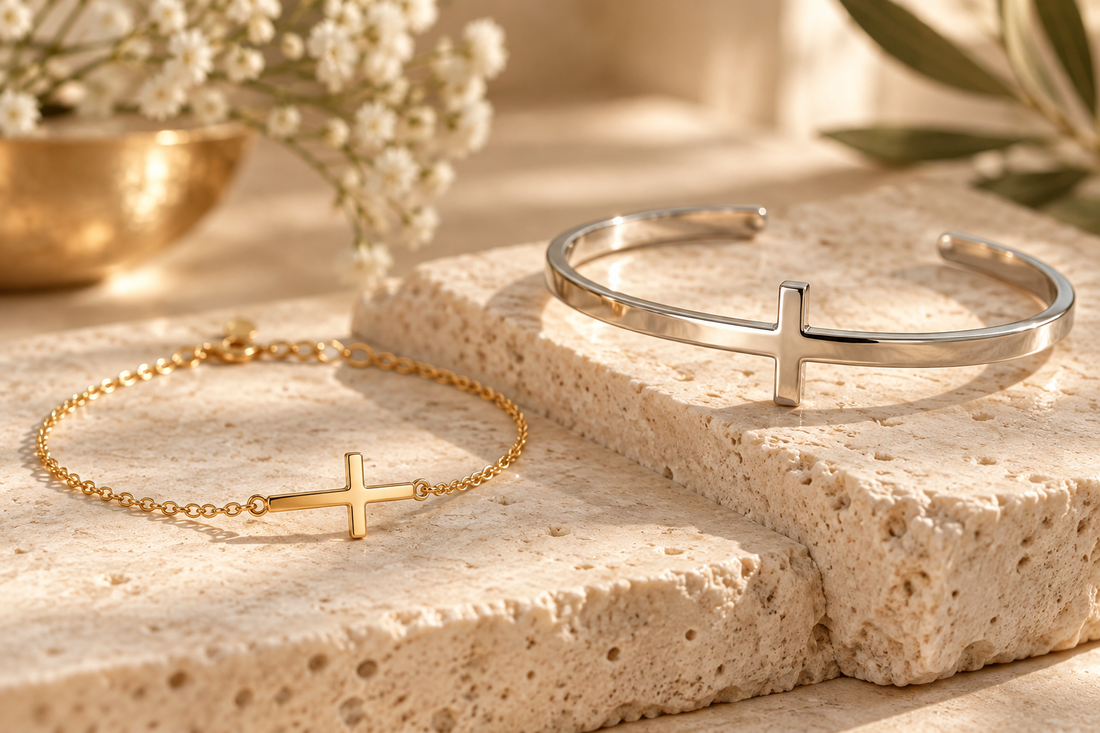 Gold and silver cross bracelets on warm ivory stone