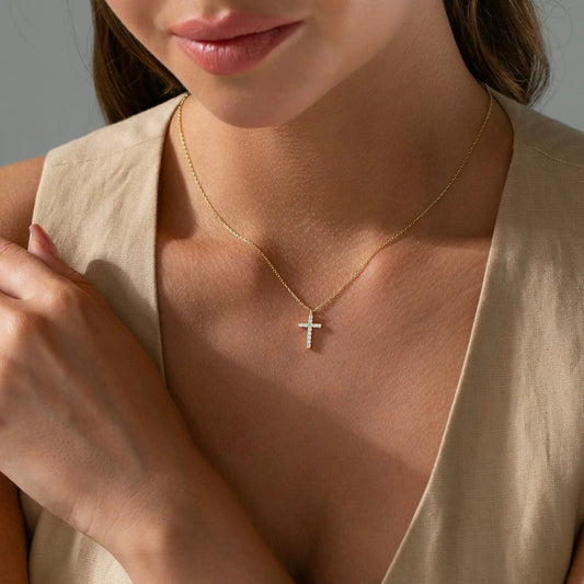 Gold cross pendant showing chain and bail alignment