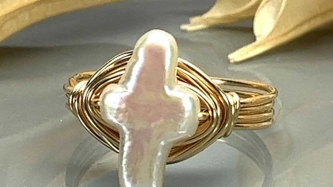 925 sterling silver cross ring beside a soft polishing cloth with a faint green oxidation illustration