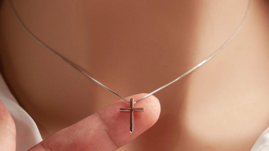 Seven necklace clasp types arranged and labeled beside a fine cross necklace
