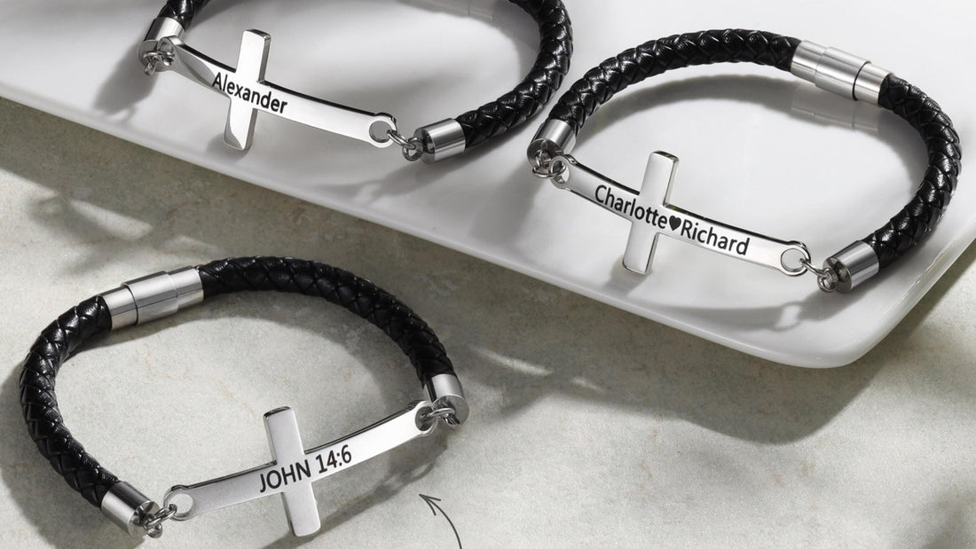 Men's leather cross bracelet resting beside a folded dry cloth on a neutral surface