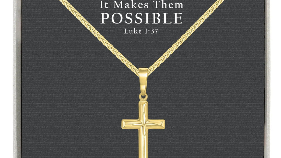 Gold-over-sterling-silver cross necklace beside a clean polishing cloth