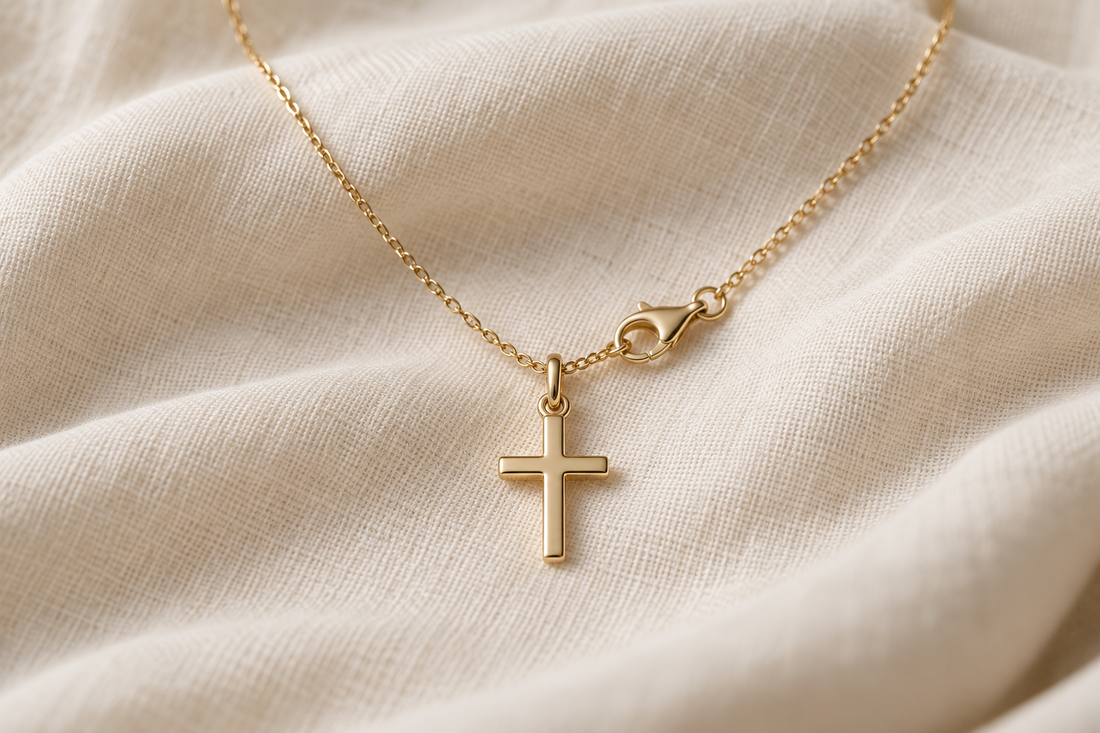 Necklace clasp that has moved beside a gold cross pendant
