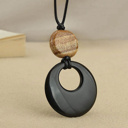 Collier pendentif en cuivre avec pierre d'obsidienne noire Liuli et image de Bouddha
