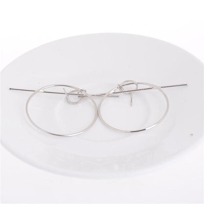 Boucles d'oreilles créoles et barres géométriques